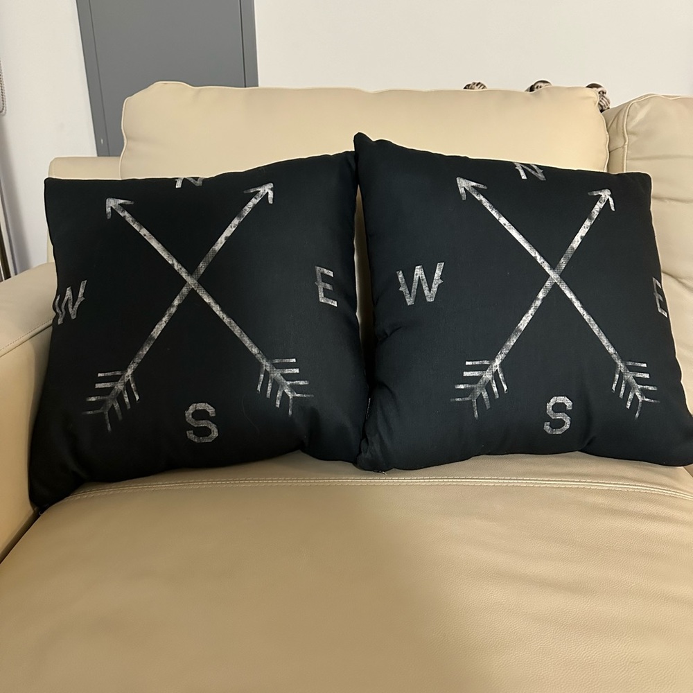 Black accent throw pillows with compass design